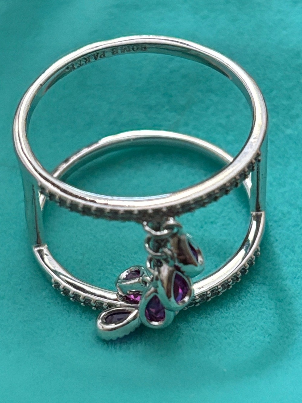 BP ring, size 10 with fuchsia colored dangling pear shaped stones.